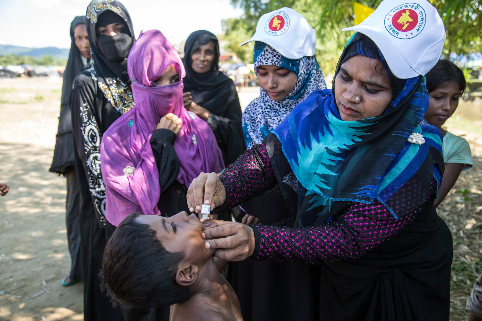 A Rohingya refugee receives a dose of an oral cholera vaccine at a makeshift refugee settlement in Bangladesh. Photo credit: UNICEF / Roger LeMoyne