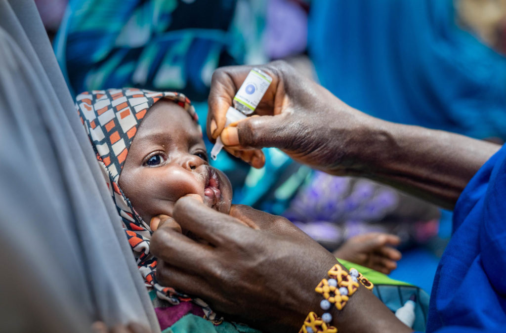 On 13 March 2020 in Fanisau Ugongo Village in Kano State, Nigeria, a Volunteer Community Mobilizer (VCM) receives a dose of the oral polio vaccine during a child naming ceremony. VCMs often take advantage of community gatherings such as naming ceremonies and other events to talk with parents and care-givers about vaccination and other healthy practices – and to vaccinate children against polio. Nigeria has crossed over three years without a single child being paralyzed by the wild polio virus and is on track to be certified wild polio virus free along with the African region in 2020. However, the government and GPEI partners continue supporting efforts to immunize the country’s 55.5 million children under five years of age to maintain the ‘zero polio case’ status and rid the country of all forms of the polio virus.