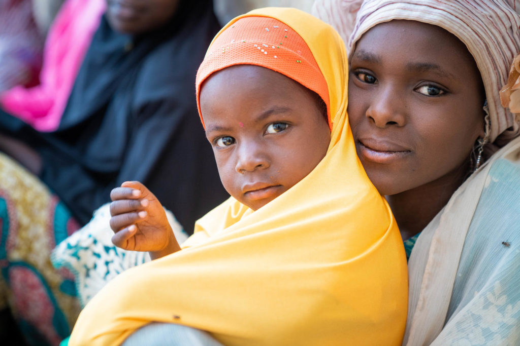 On 13 March 2020 in Fanisau Ugongo Village, Kano State, Nigeria, Fatima (right), 13, and her sister, Amina, 3, with their mother (not pictured), take part in a community meeting of local women lead by Volunteer Community Mobilizer (VCM) Laira Dauda (not pictured). VCMs are a vital relay in communicating vital public health messaging. Approximately 18,000 VCMs, over 90 prevent of whom are women, are at the centre of Nigeria’s polio eradication programme. Supported by UNICEF, they are from the local community and are trusted by parents and caregivers on information related to vaccines and other health practices for their well-being of their children. VCMs have also built critical relationships with traditional leaders, religious clerics and other local influencers to build trust in polio and other vaccines in the community. Nigeria has crossed over three years without a single child being paralyzed by the wild polio virus and is on track to be certified wild polio virus free along with the African region in 2020. However, the government and GPEI partners continue supporting efforts to immunize the country’s 55.5 million children under five years of age to maintain the ‘zero polio case’ status and rid the country of all forms of the polio virus.