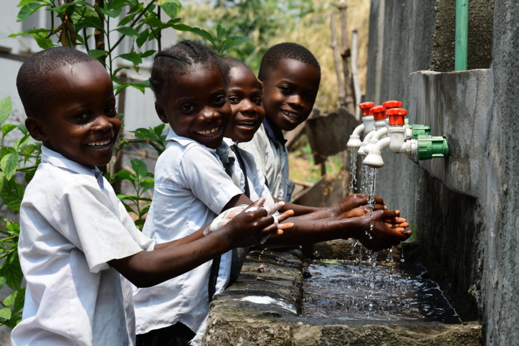 Children washing their hands at their school 