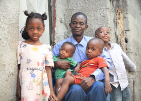 Polio survivor with her father and siblings in the DRC. Polio vaccines protecting children.