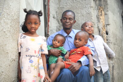 Polio survivor with her father and siblings in the DRC. Polio vaccines protecting children.